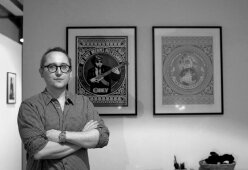Matthew Fargher at home in front of his Shepard Fairey prints. Image: © Florence Early